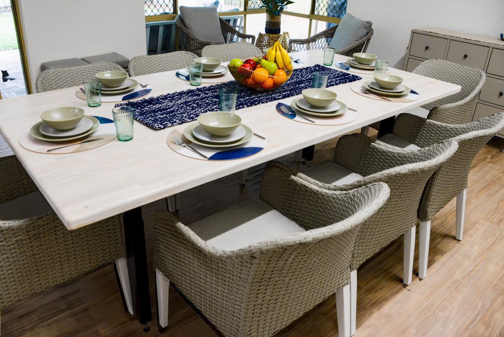 Adjustable dinner table set ready for a meal